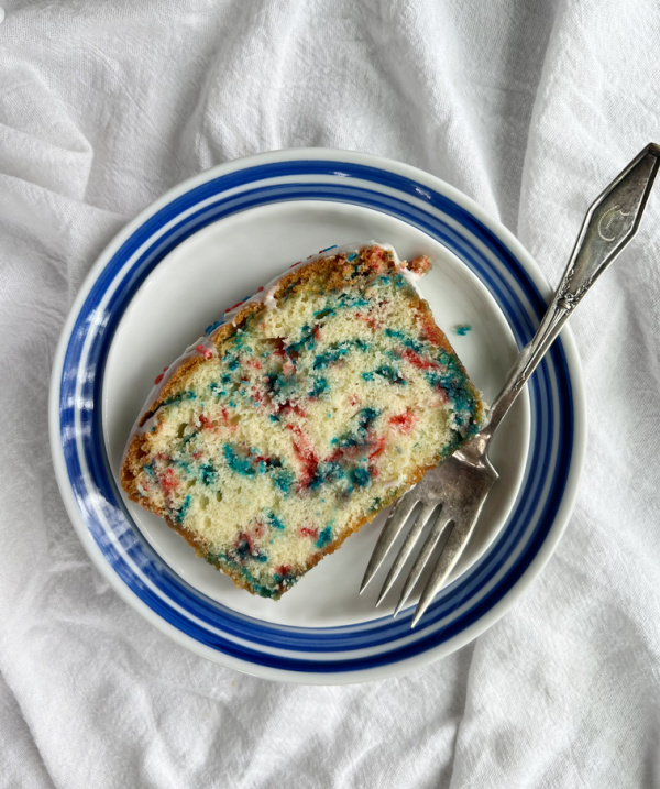 Funfetti pound cake slice on a plate with a fork.
