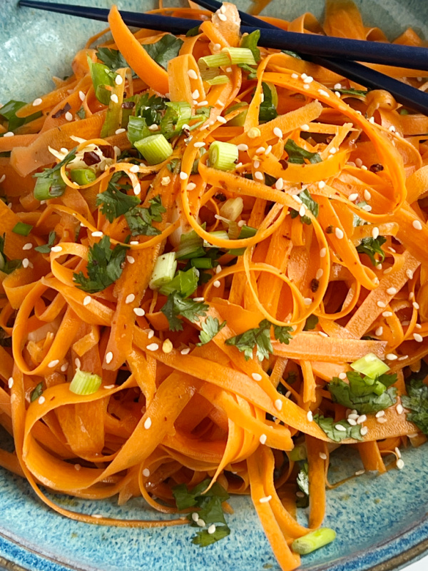Raw Carrot Salad in a blue bowl.