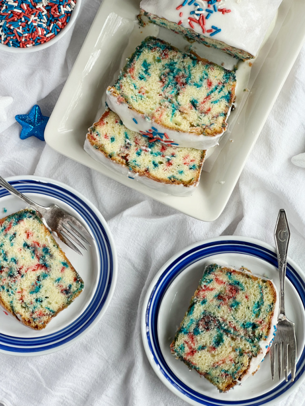 Slices of pound cake with sprinkles on plates.