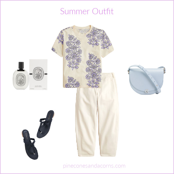 Summer Outfit with a white and purple flower shirt, white pants, navy sandals and a light blue cross body bag.