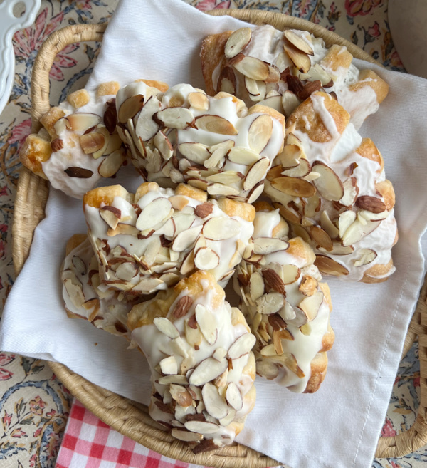 almond bear claws on a wicker tray.