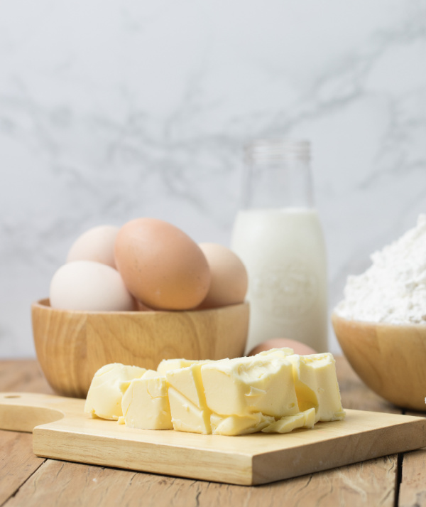 eggs, butter flour on a cutting board. 
