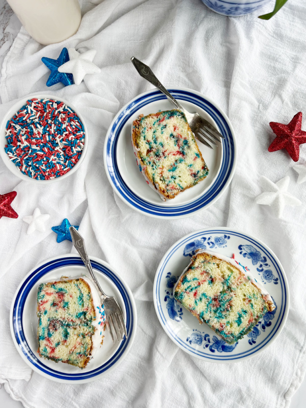 slices of 4th July Funfetti pound cake on blue and white plates. 
