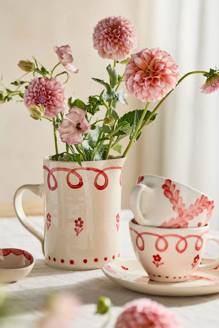 red and white coffee mugs and a red and white pitcher with flowers.