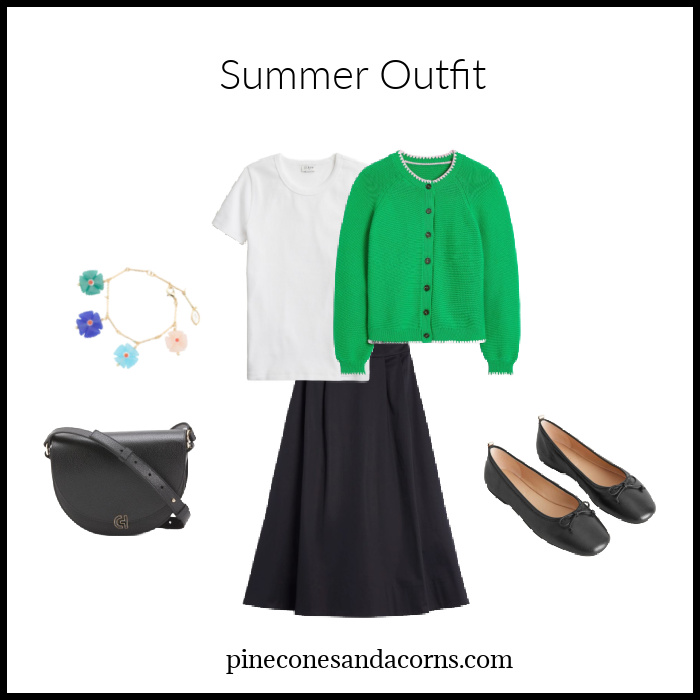 Summer Skirt outfit Fashion over 50 with a green sweater, black skirt, shoes and bag.