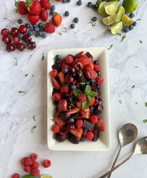 beet and berry salad with scattered berries.