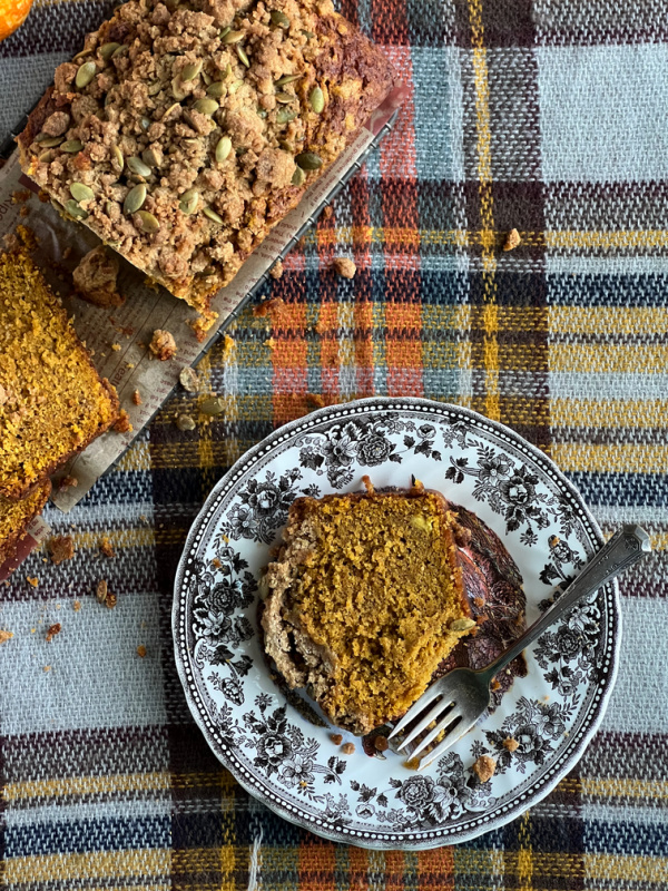 Pumpkin Spice Bread with Pepita Streusel Topping, on plaid tablecloth.