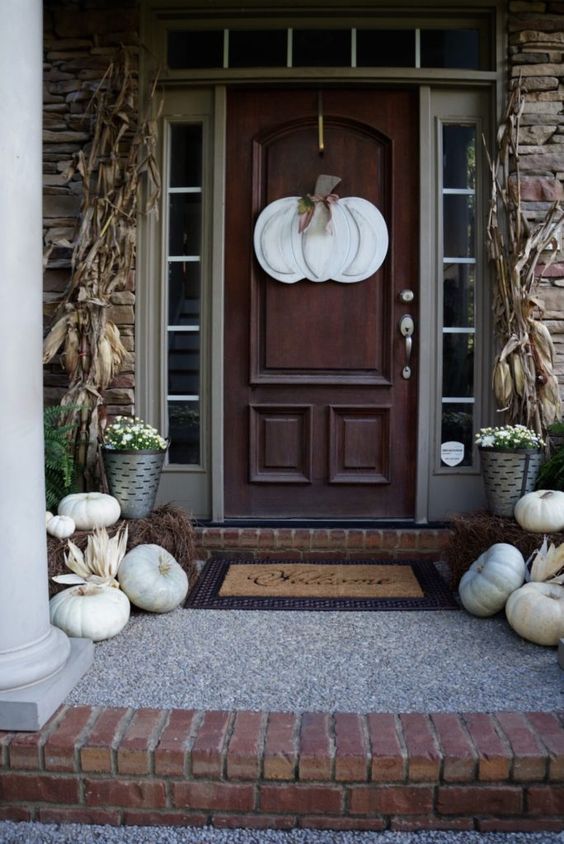 Fall porch with pumpkin on the door. 