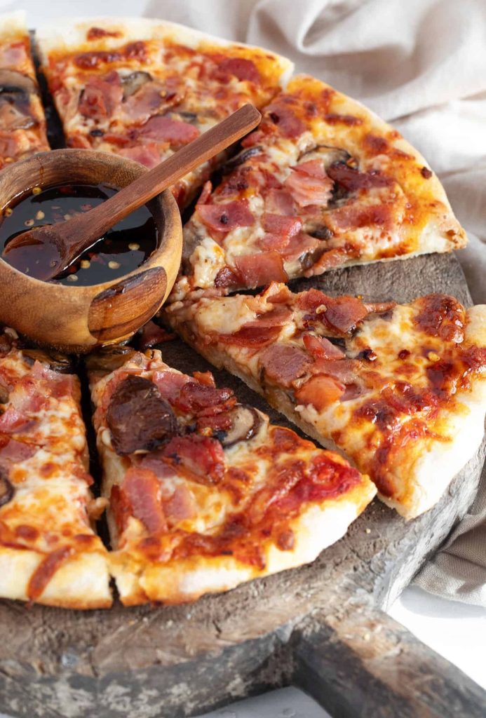Classic Canadian pizza with bacon, ham and mushrooms. Finished with a maple chili drizzle.