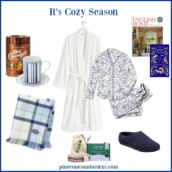 cozy Season Essentials collage with a robe, pjs, slippers, throw, hot chocolate, magazine, book and mug.
