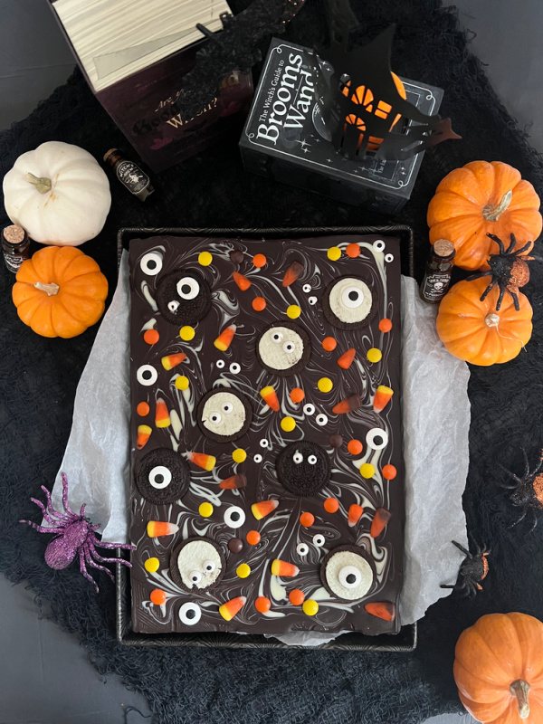 halloween chocolate bark pieces, pumpkins and books, haunted house candle flatly.