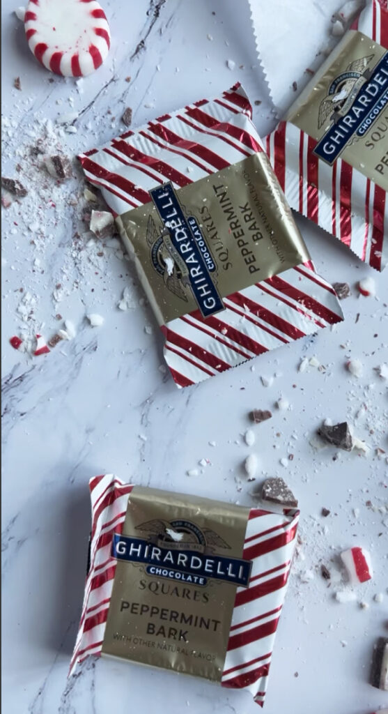 Ghirardelli peppermint bark candy and a red and white disc candy.