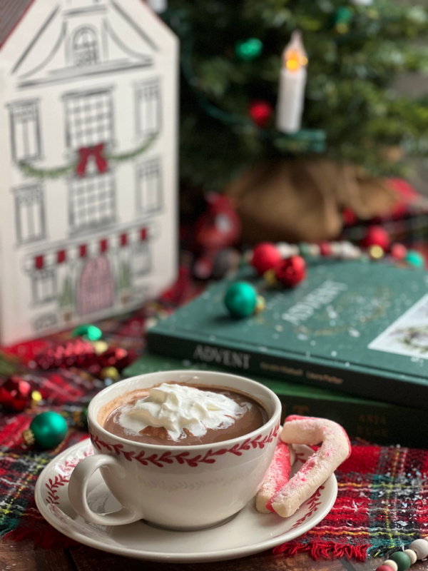 cup of hot chocolate with whipped cream and an advent calendar.