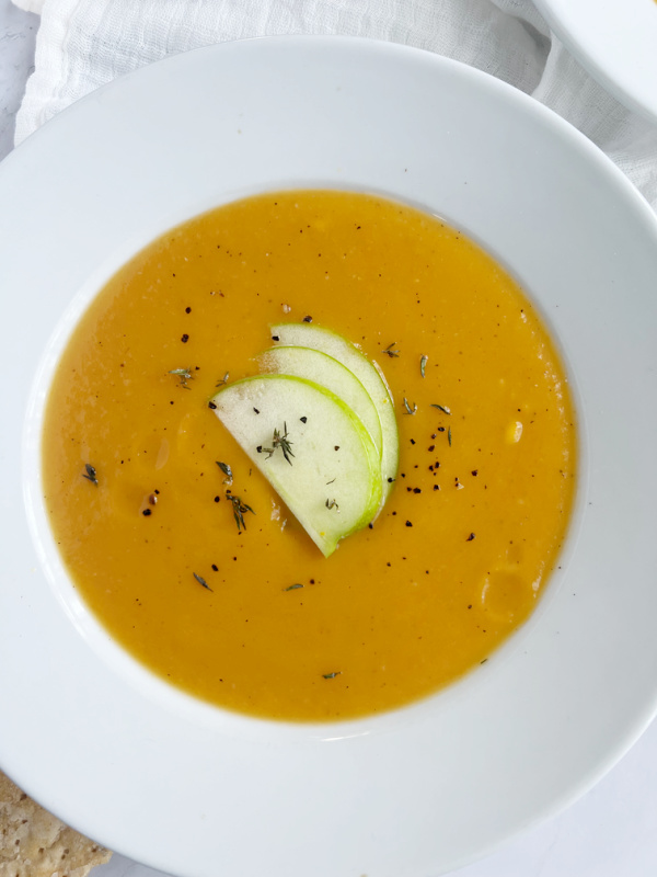 butternut squash and apple soup with sliced apples.