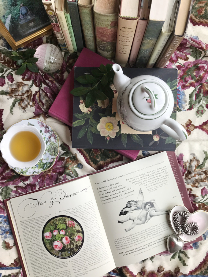 Valentine Flatlay with books, tea and a heart.