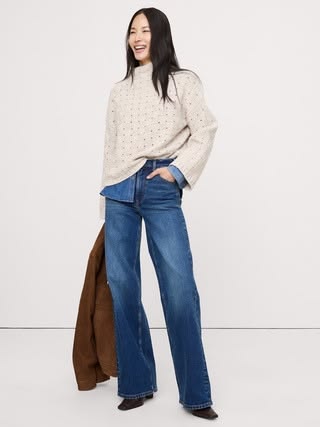 Woman wearing Banana Republic white basketweave sweater and a pair of jeans. 