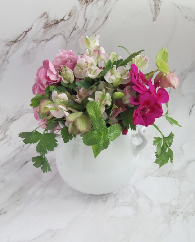 colorful spring flowers in a white ironstone vase.