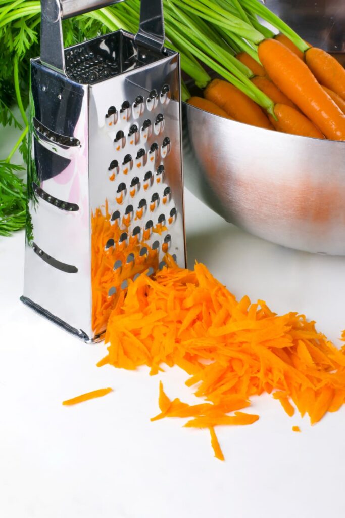 How to make grated carrot salad — grating raw carrots on a box grater for classic French carrot salad