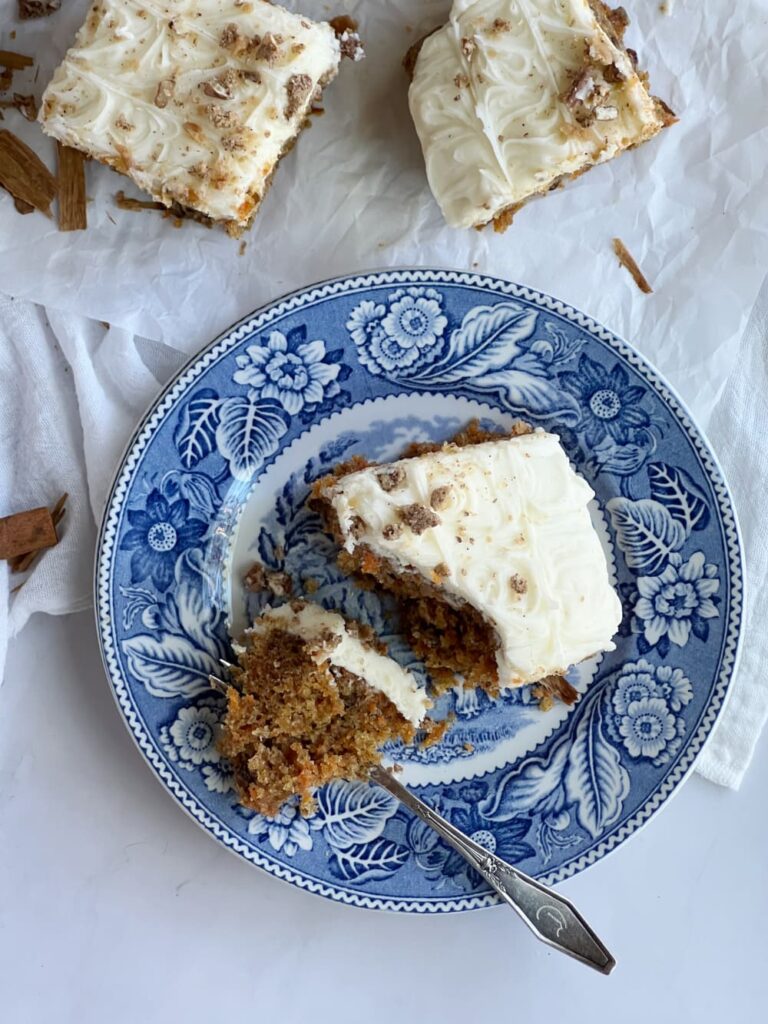 Carrot Cake on a blue and white plate with a fork. 