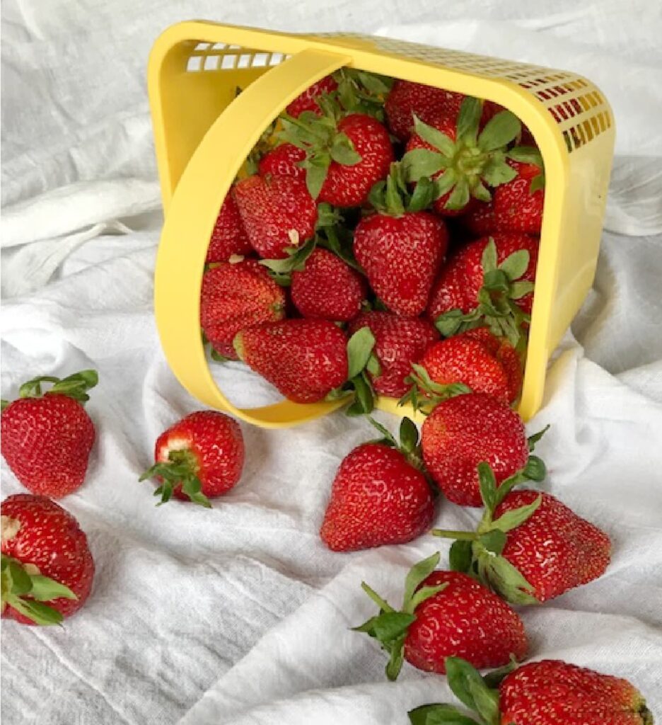 Browned butter pound cake Fresh strawberries in a yellow basket