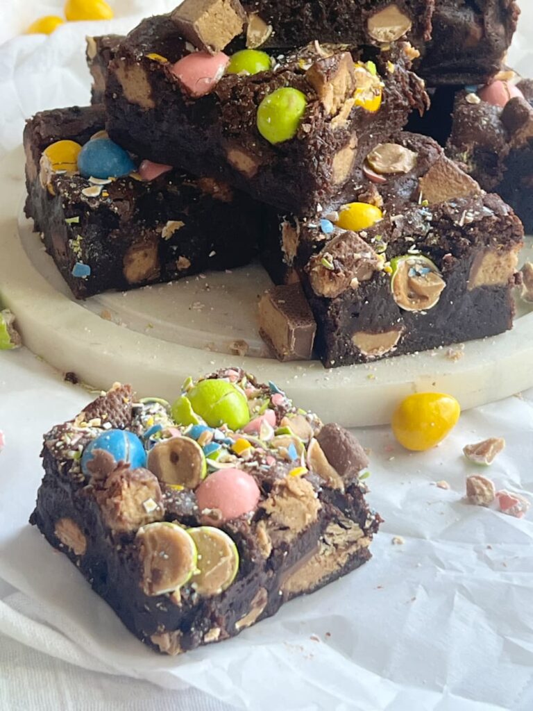 Reeses Easter brownies cut and on a piece of round marble.