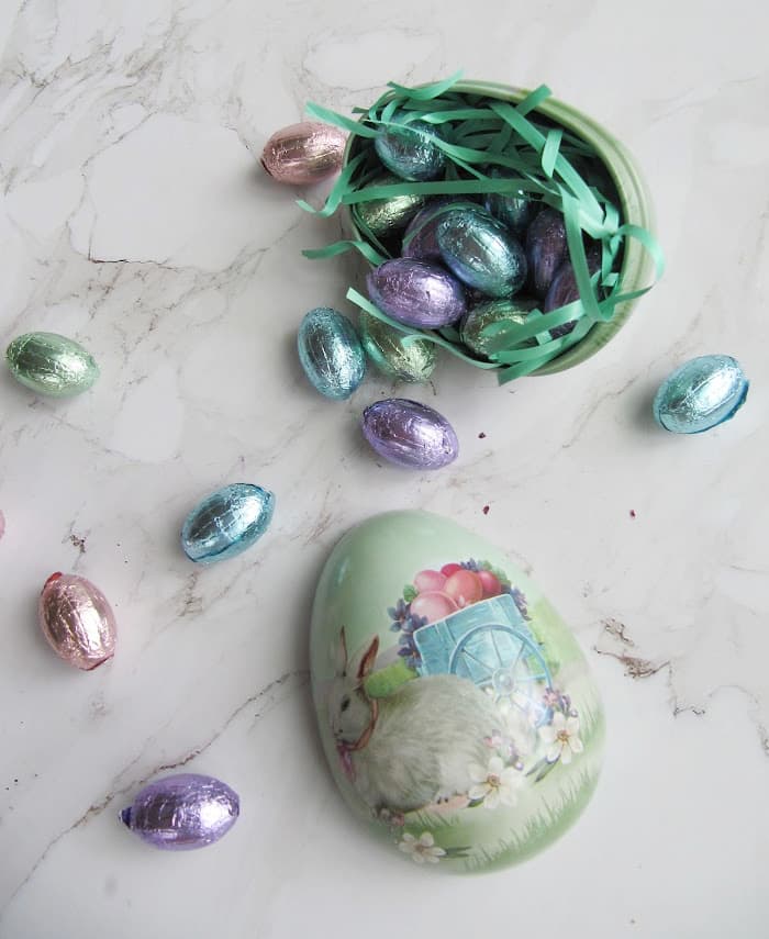 weekend meanderings easter weekend — Vintage aluminum Easter egg with a bunny filled with green grass and pastel colored chocolate eggs