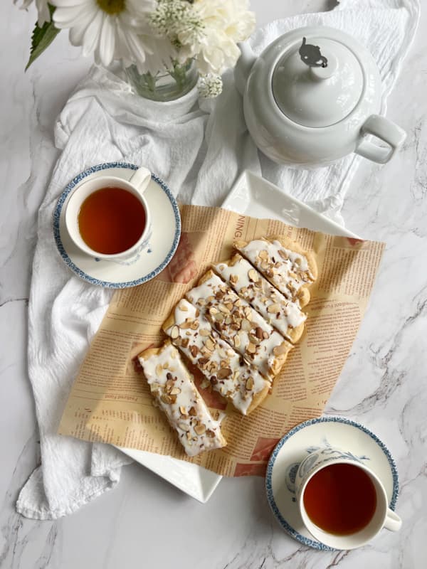 almond-puff-pastry-swedish-Kringle-with-2-cups-of-coffee-and-a-pot-of-tea