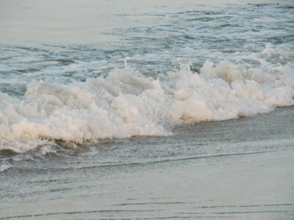 slow morning ritual women over 50, walk on the beach waves along the shore
