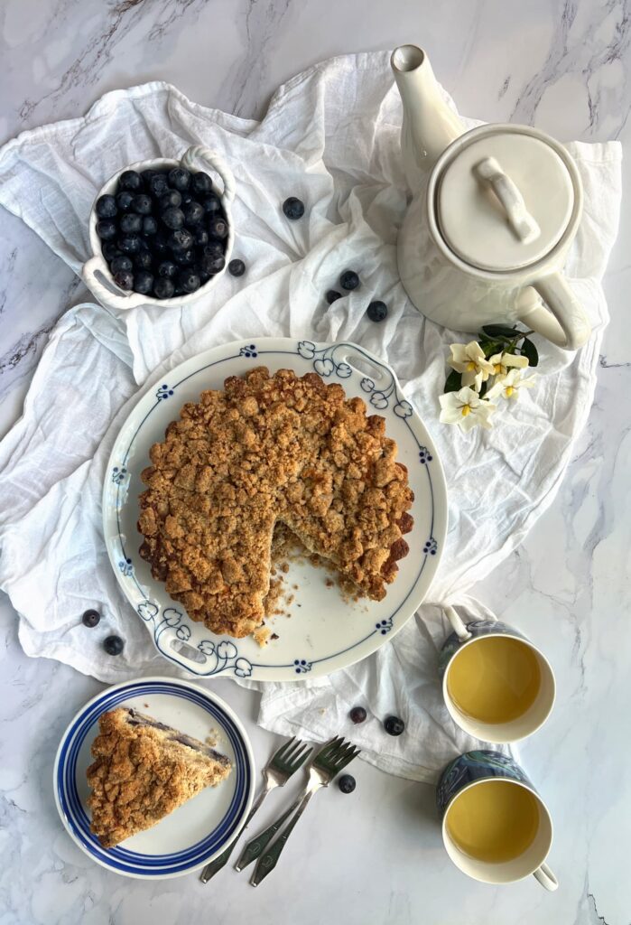 Ina Garten blueberry Crumb Cake sliced with 2 cups of tea