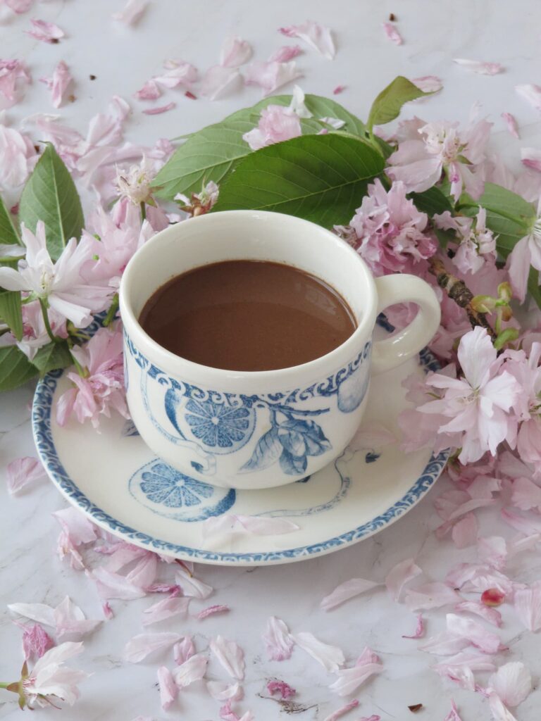 Self Care Over 50 cup of drinking chocolate and flowers
