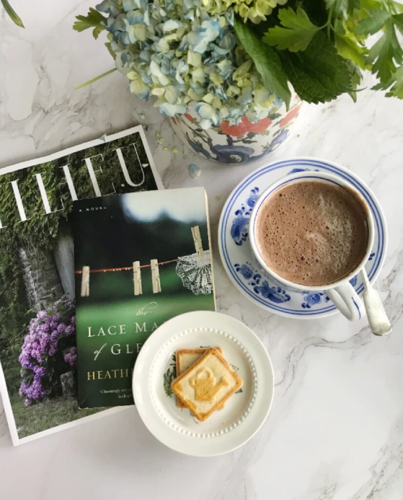 Self Care after 50 a book, magazine, flowers and a cup of chocolate