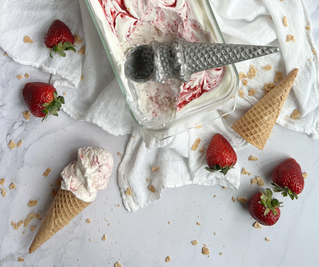 scoops of strawberry no-churn swirl ice cream in sugar cone