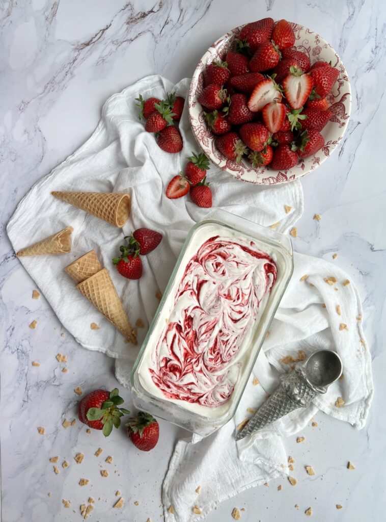 strawberry no-churn swirl ice cream with sugar cones and a bowl of fresh strawberries