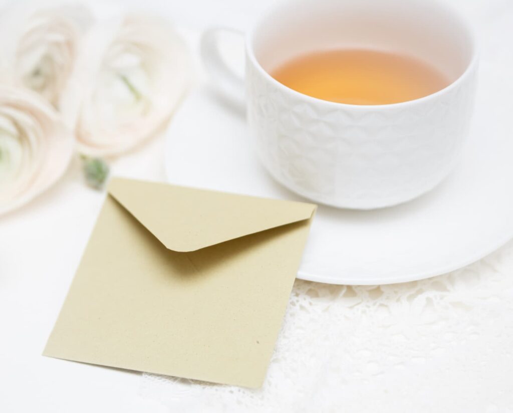 A teacup and spring flowers on a linen cloth for Mother’s Day