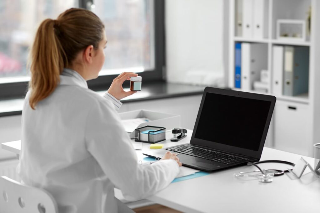 Doctor at computer talking about perimenopause and menopause