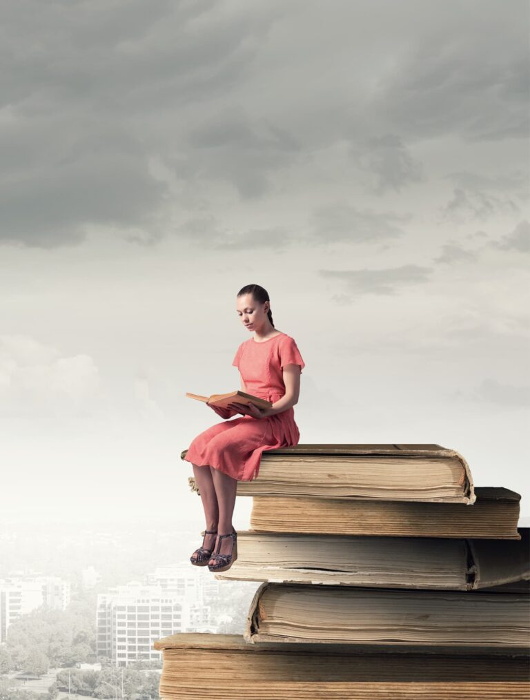 Woman looking for answers about menopause -- the manual nobody wrote, woman sitting on a stack of books reading.