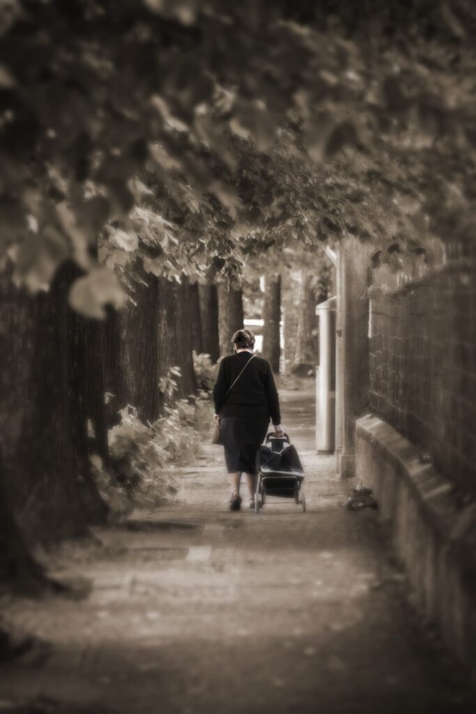 woman walking confidently on a tree-lined path