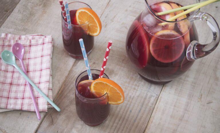 July musings — a glass of sangria on a garden table in summer afternoon light