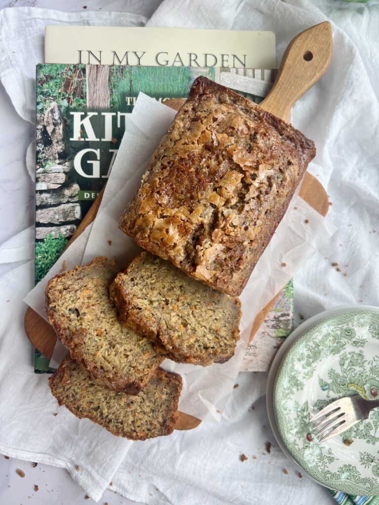 carrot zucchini banana bread sliced on a wood cutting board