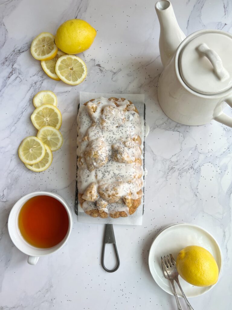 lemon poppyseed loaf cake with tangy lemon glaze and a cup of tea