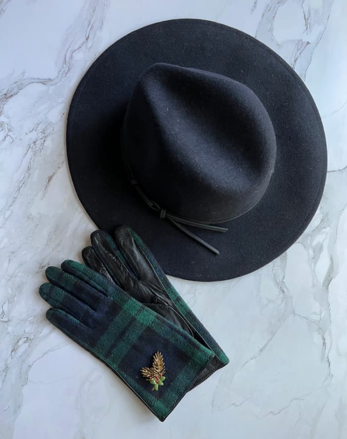 Blue-wool-had-tartan-plaid-gloved-and-a-pinecone-brooch.