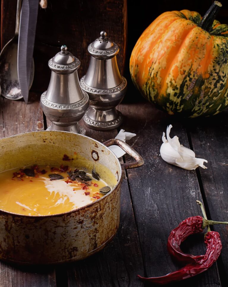 pot of soup a pumpkin and silver salt and pepper shakers