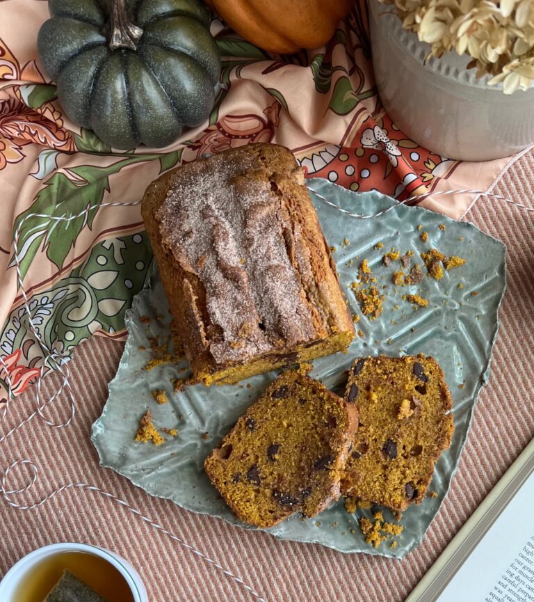 flatlay chocolate chip pumpkin bread on a green pottery platter