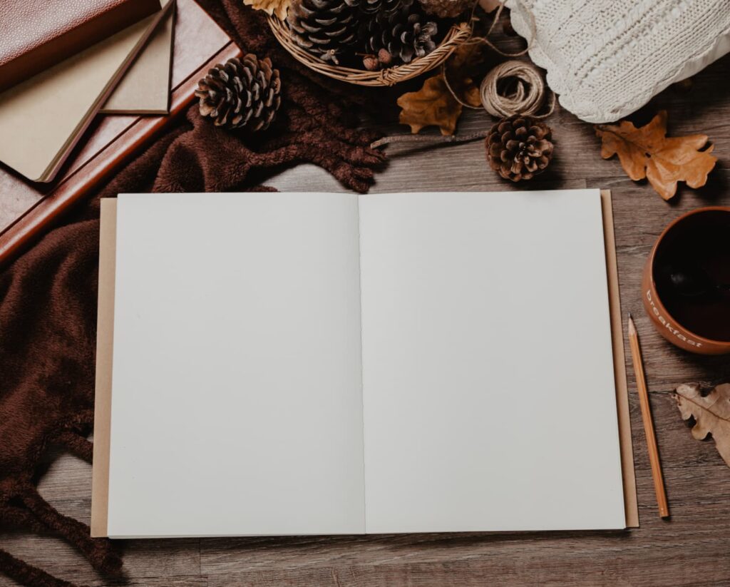open journal on a desk with fall light