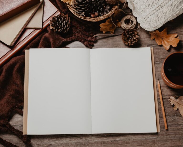 open journal on a desk with fall light