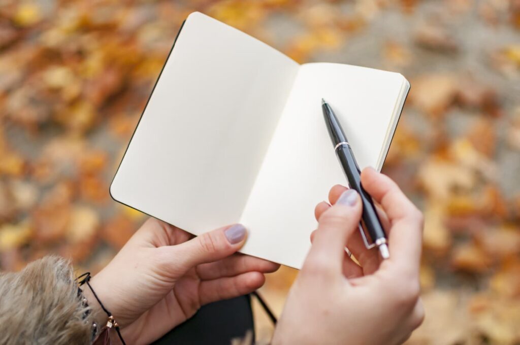 woman writing notebook fall