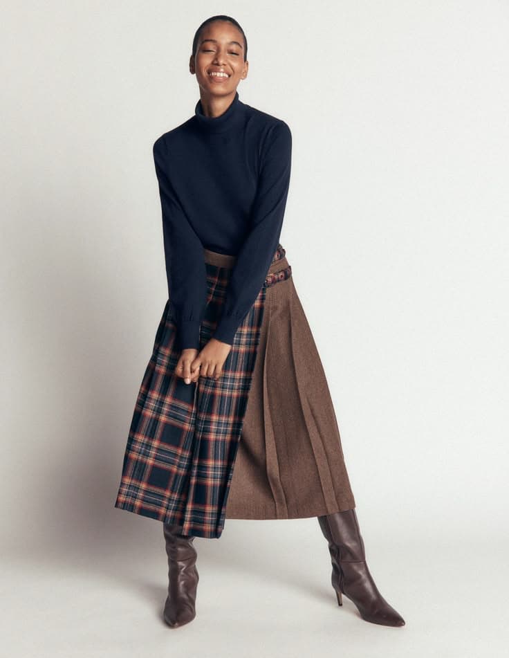 Cashmere sweater with a plaid skirt and boots, a classic fall outfit after 50
