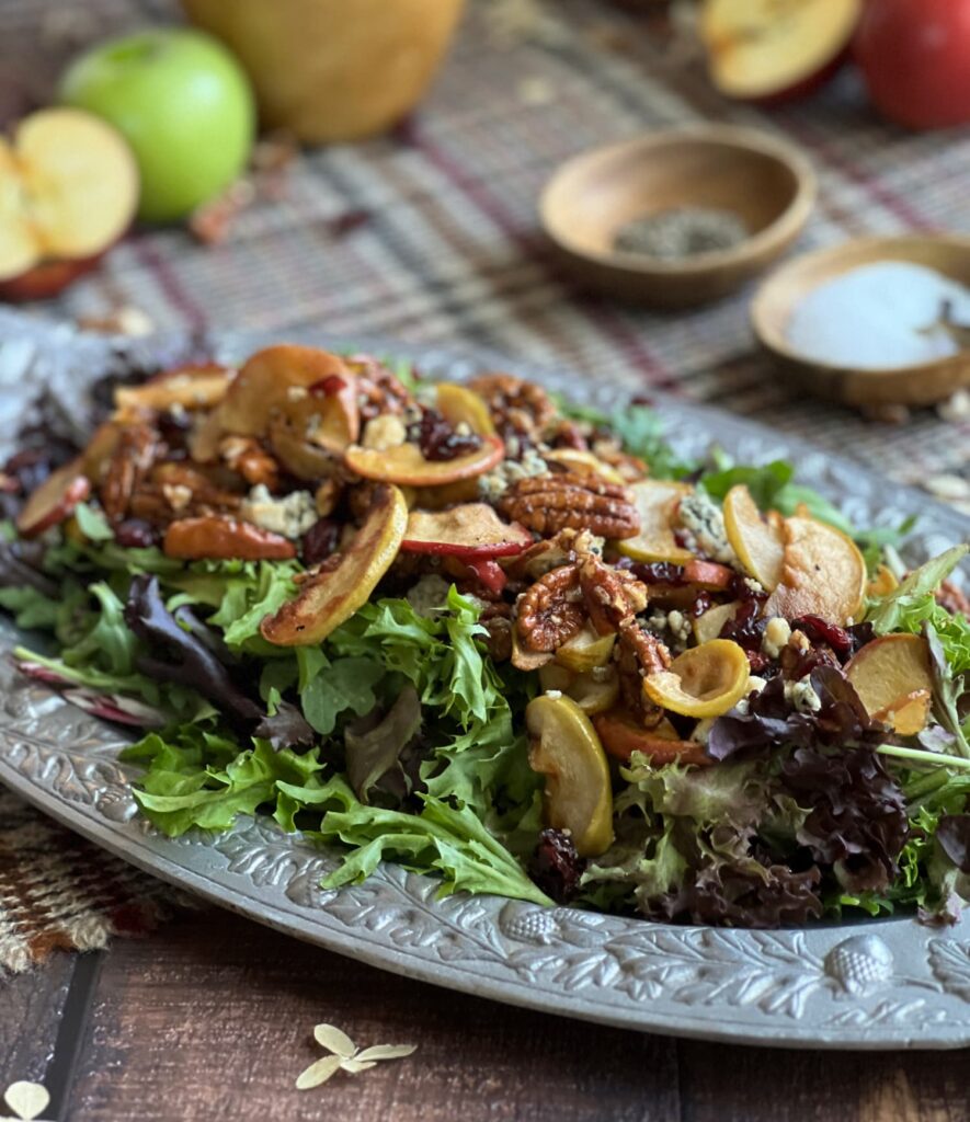 Roasted apple salad with pecans on a silver tray
